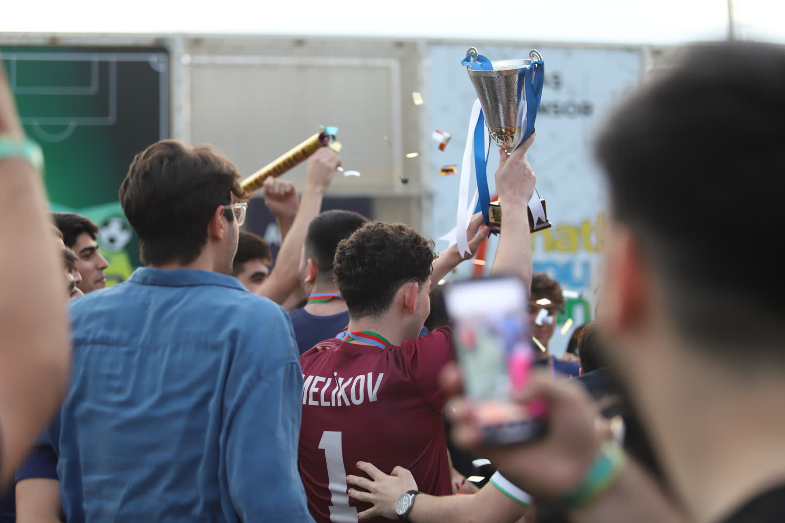 Teyyub with the cup raised above his head, MELIKOV 1 on the back of his shirt